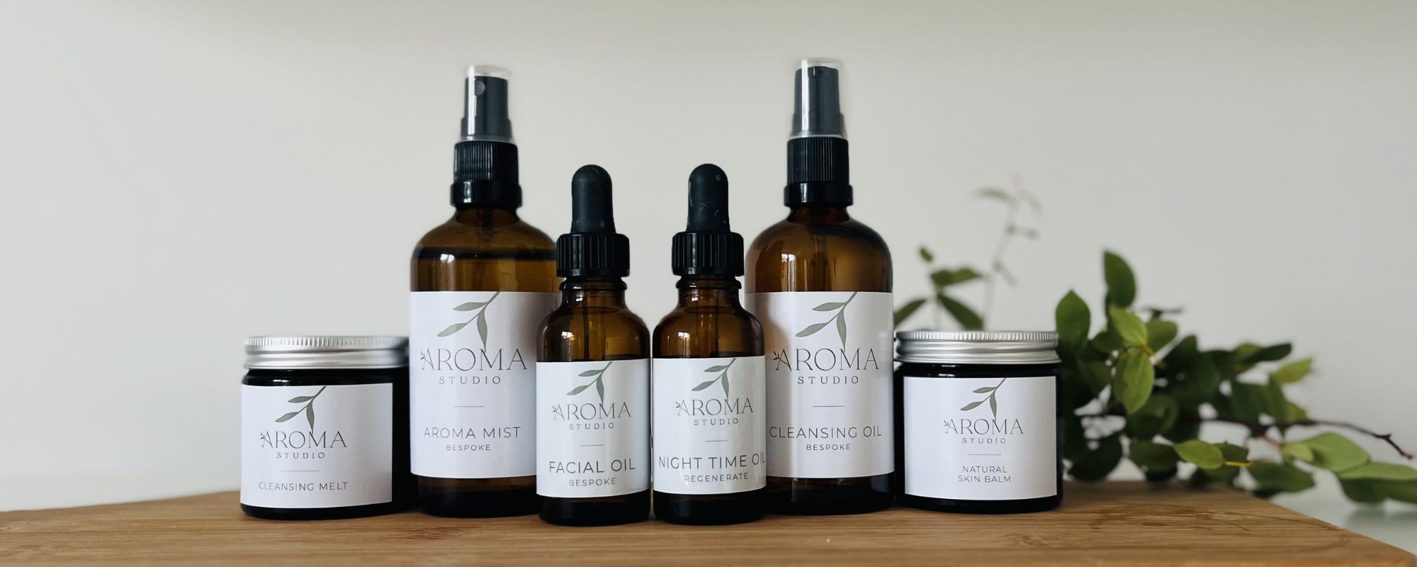 Aroma Studio - An array of bespoke natural skincare products on a wooden table